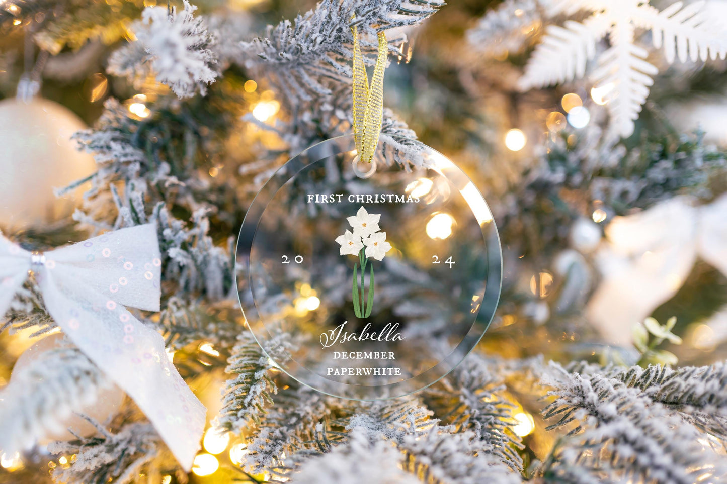 Personalized Baby&#39;s First Christmas Ornament 2024, Custom December Birth Flower Glass Ornament gift hanging on a cute christmas tree with gold ribbon decorated with trendy ribbons. Paperwhite Narcissus art by Danielle Silvie D&#39;Elia.